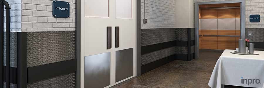 Back of a facility with stainless steel  door and wall protection and an open elevator