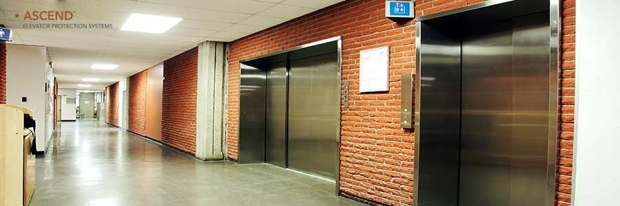 Hallway with several large elevators.