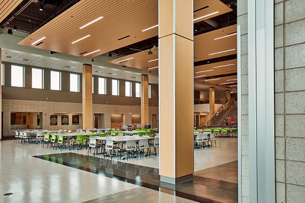 A school cafeteria with many tables and chairs