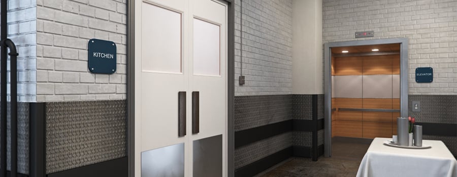 A back of house hallway with an open elevator.