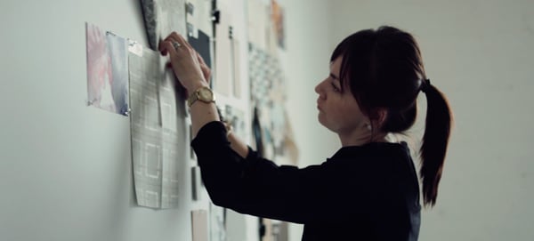 Interior Designer, Aga Artka, creates a flat lay on a wall by placing items of inspiration and  swatches representing trends in colors, fabrics, and prints. 