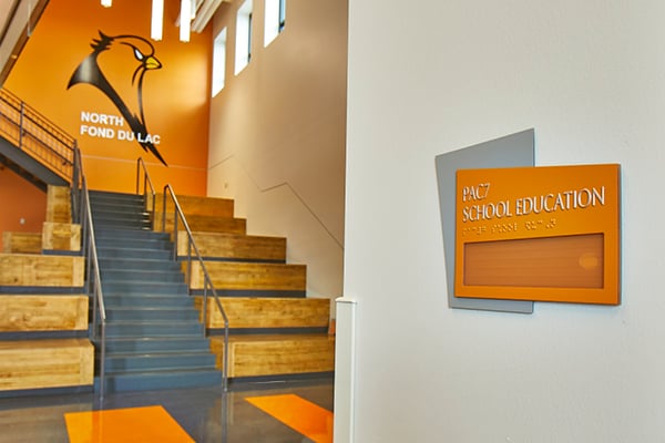 A staircase and risers to the left of an architectural sign.
