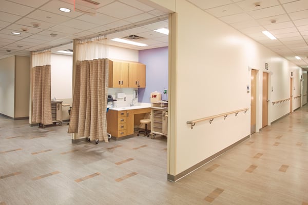 Antimicrobial curtains are shown hung in a healthcare facility that adds to the design but not jeopardize the cleanliness of the space.