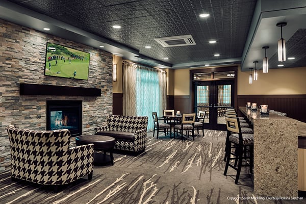 A warm and rustic-sytled eating and lounge area with rod pocket drapery from Inpro.