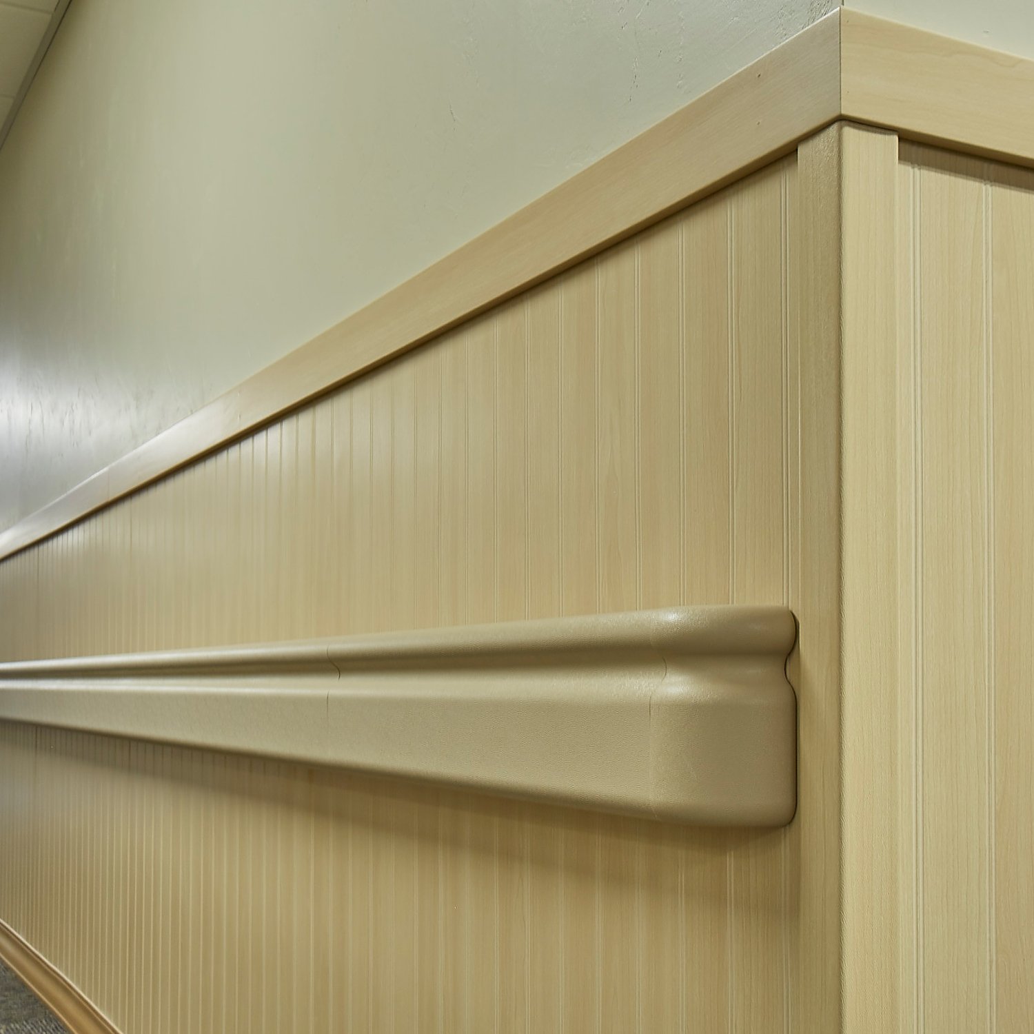 Close up view of rigid vinyl beadboard in light wood grain finish