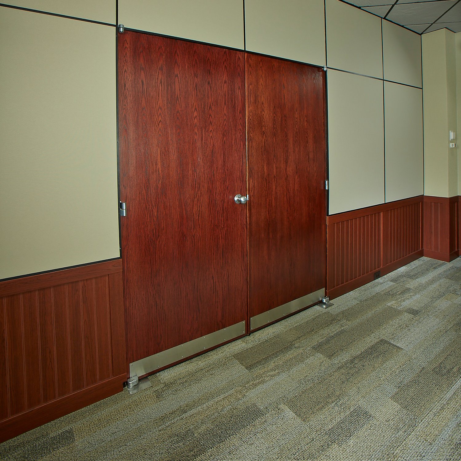Rigid vinyl beadboard adjoining a doorway in wood grain finish